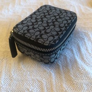 Like new never used Coach pill box in black and grey